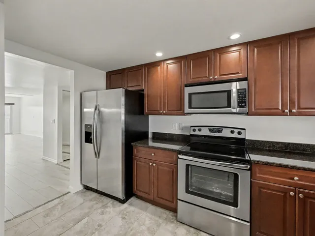 a kitchen with a refrigerator stove and microwave