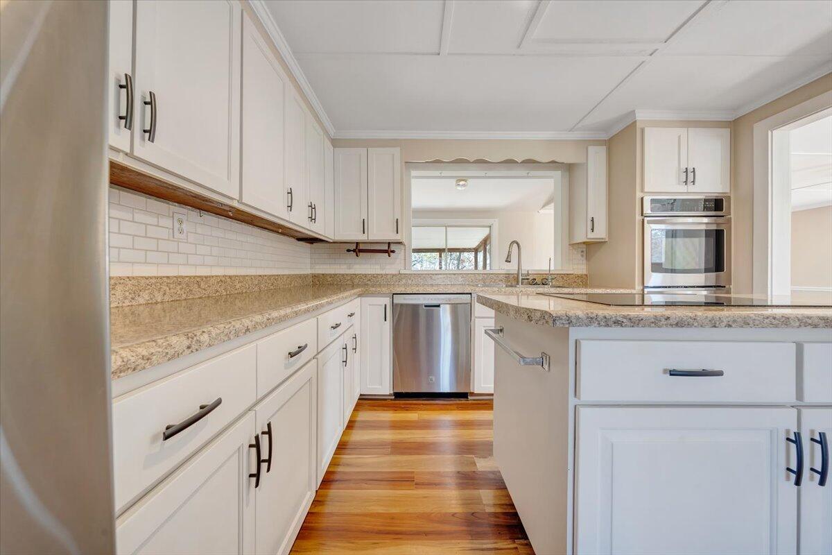 460 Thompson Ridge Road Ferrum, VA 24088 - Photo 15 of 48 a kitchen with granite countertop stainless steel appliances and white cabinets