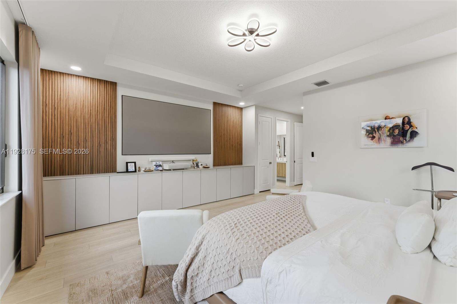 12070 Southwest 83rd Place Miami, FL 33156 - Photo 22 of 42 a bedroom with a bed and a chandelier