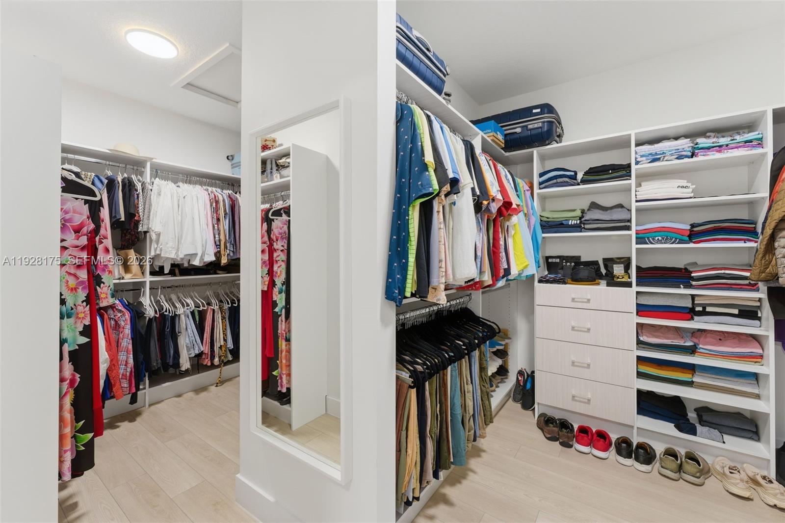 12070 Southwest 83rd Place Miami, FL 33156 - Photo 25 of 42 a view of walk in closet with clothes and shoes