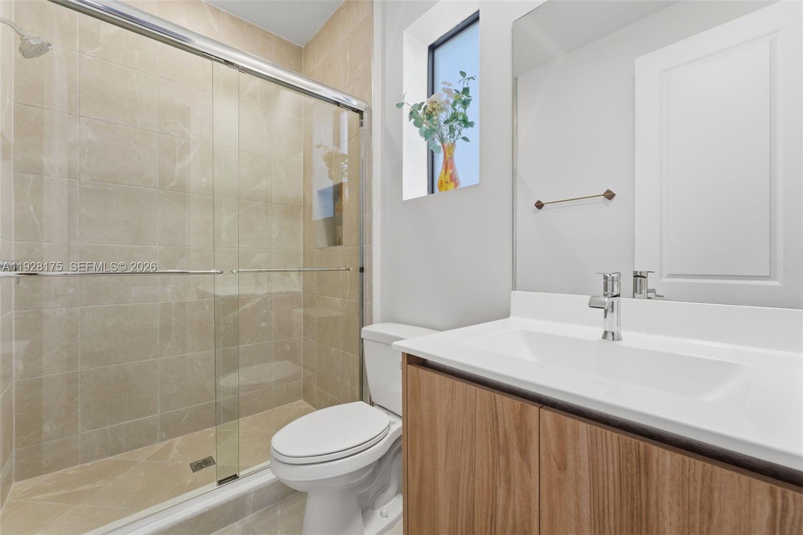 12070 Southwest 83rd Place Miami, FL 33156 - Photo 27 of 42 a bathroom with a sink a toilet and shower