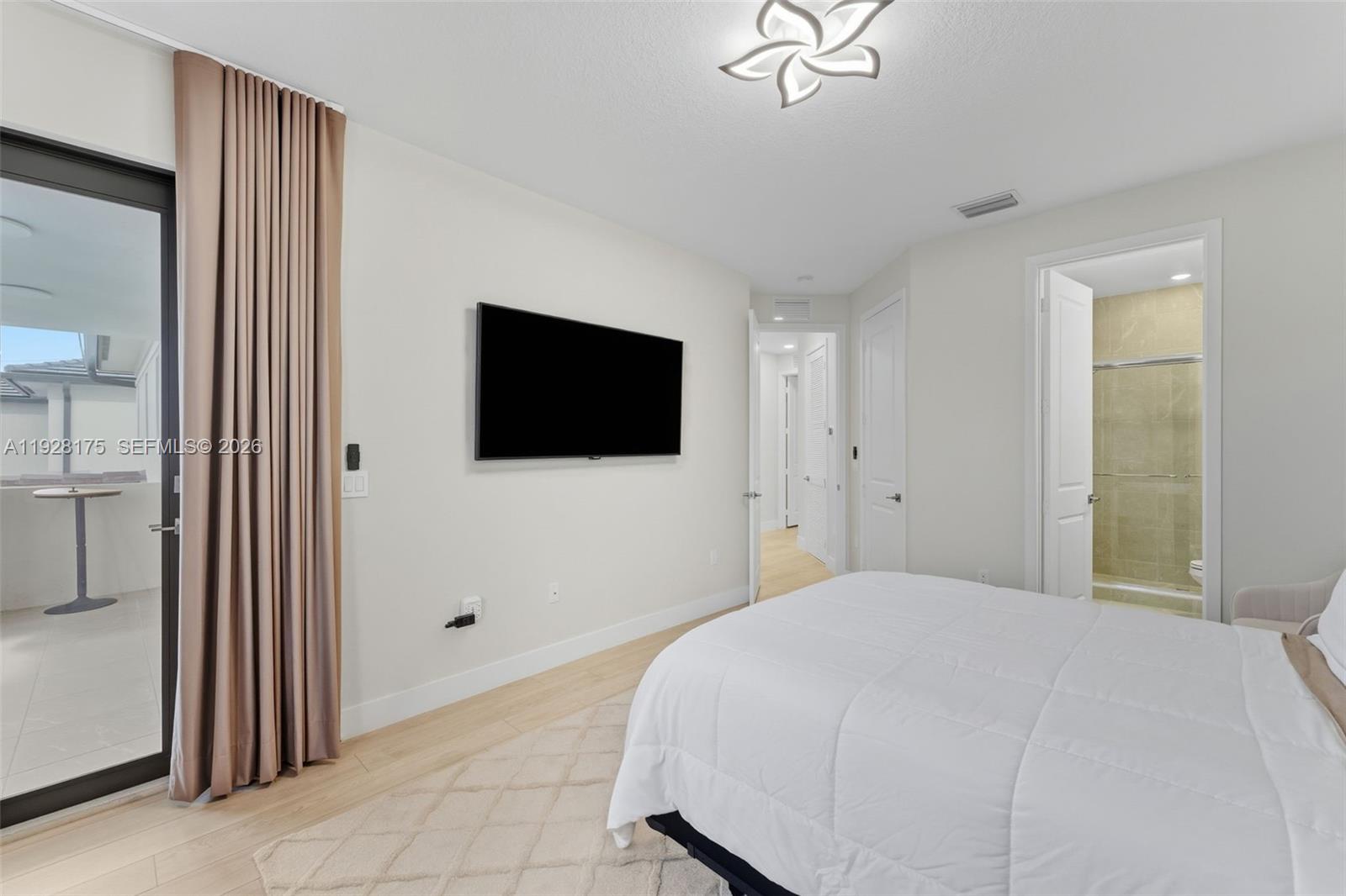 12070 Southwest 83rd Place Miami, FL 33156 - Photo 29 of 42 a bedroom with a bed and a flat screen tv