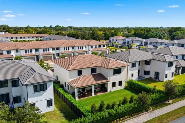 a aerial view of a houses with a big yard