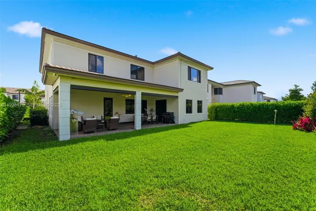 a view of a house with a yard and sitting area