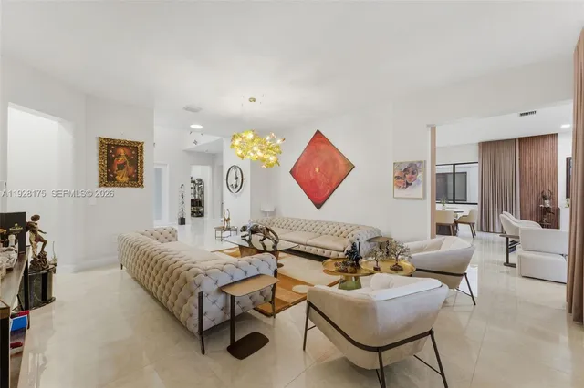 a living room with furniture and wall paintings
