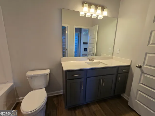 a bathroom with a double vanity sink toilet and shower