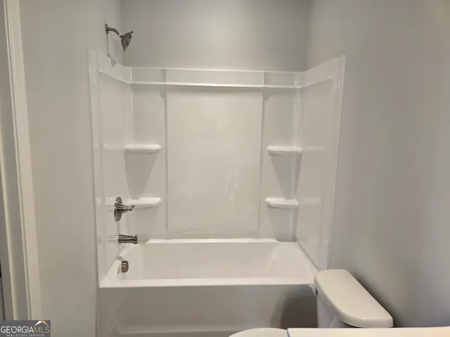 a bathroom with a glass shower door