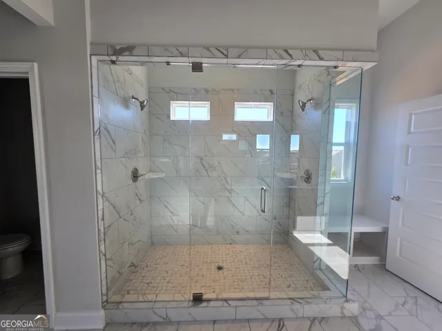 an empty room with windows and closet