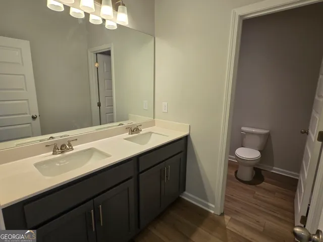 a view of swimming pool with seating area and trees in the background