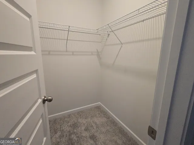 a sign board with tall buildings in the background