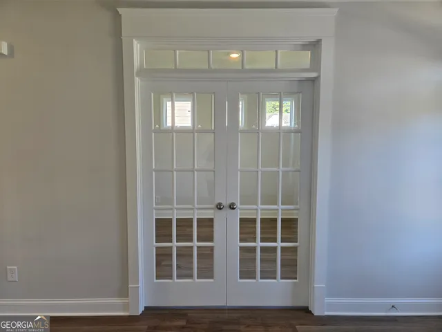 a view of entryway and hall with wooden floor