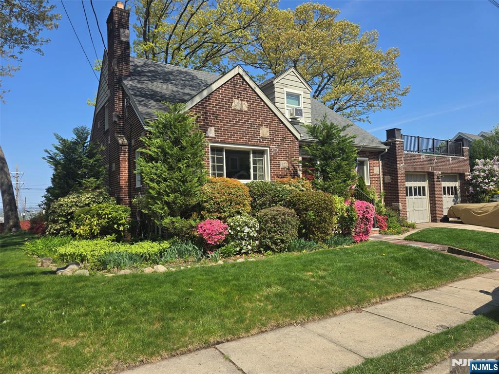 585 Monroe Place Ridgefield, NJ 07657 - Photo 2 of 28 a front view of house with yard and green space