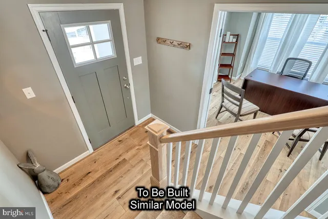 a view of an entryway with wooden floor