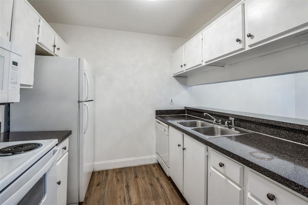 2200 East Trinity Mills Road, Unit 206 Carrollton, TX 75006 - Photo 11 of 24 a kitchen with stainless steel appliances granite countertop a sink stove and refrigerator