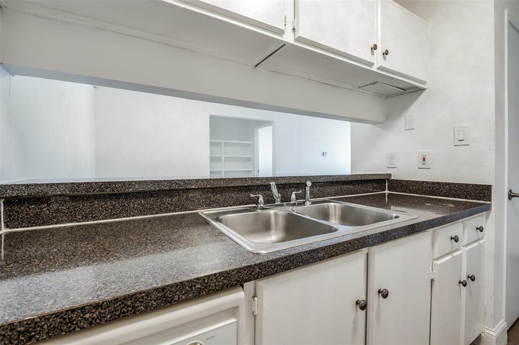 2200 East Trinity Mills Road, Unit 206 Carrollton, TX 75006 - Photo 13 of 24 a kitchen with a sink and cabinets