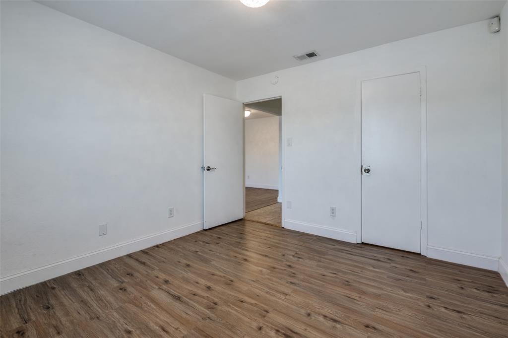 2200 East Trinity Mills Road, Unit 206 Carrollton, TX 75006 - Photo 16 of 24 a view of an empty room with wooden floor