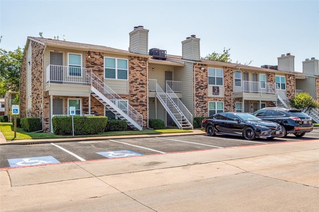2200 East Trinity Mills Road, Unit 206 Carrollton, TX 75006 - Photo 2 of 24 a car parked in front of a building