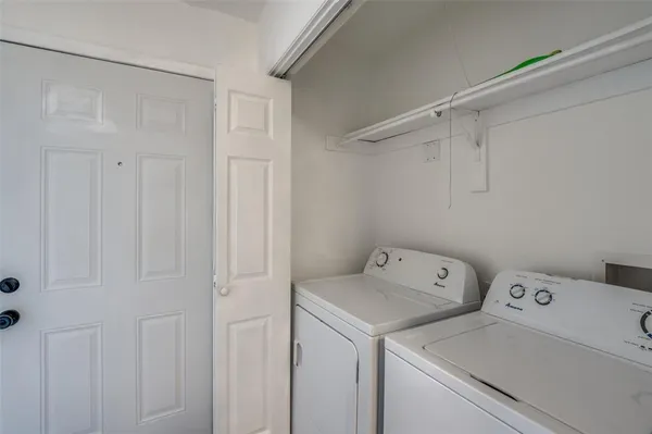 a view of storage and utility room with washer and dryer