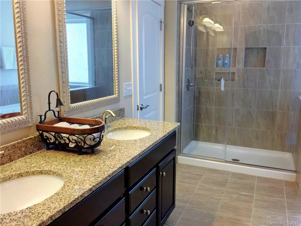 2257 Bluebell Way, Unit 23 Tega Cay, SC 29708 - Photo 14 of 24 a bathroom with a granite countertop sink and a mirror