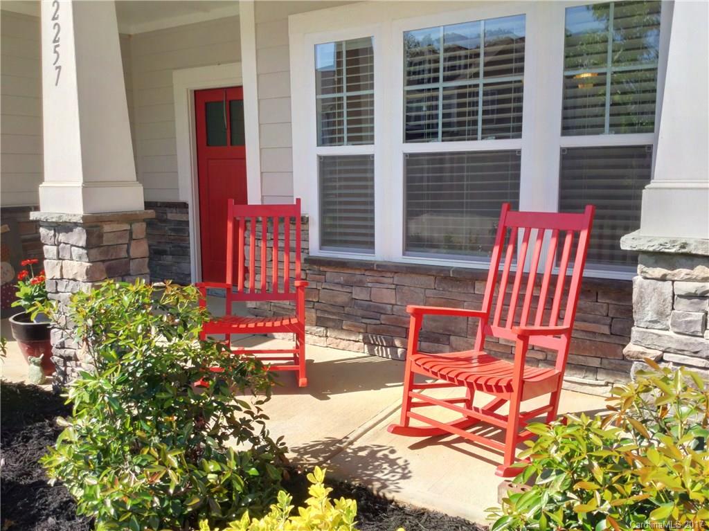 2257 Bluebell Way, Unit 23 Tega Cay, SC 29708 - Photo 3 of 24 a view of a chairs and table in the back yard of the house