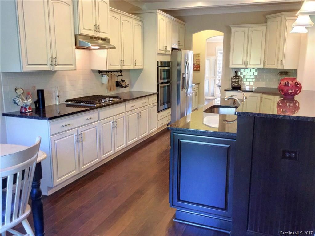 2257 Bluebell Way, Unit 23 Tega Cay, SC 29708 - Photo 5 of 24 a kitchen with stainless steel appliances sink refrigerator and window