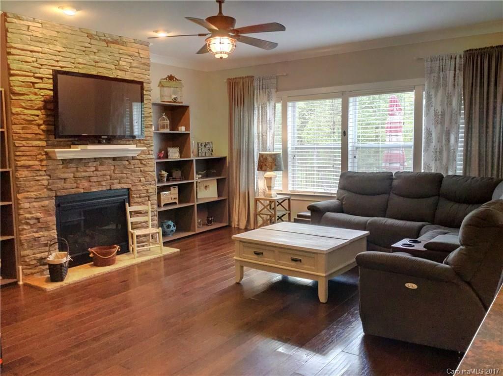 2257 Bluebell Way, Unit 23 Tega Cay, SC 29708 - Photo 8 of 24 a living room with furniture a flat screen tv and a fireplace