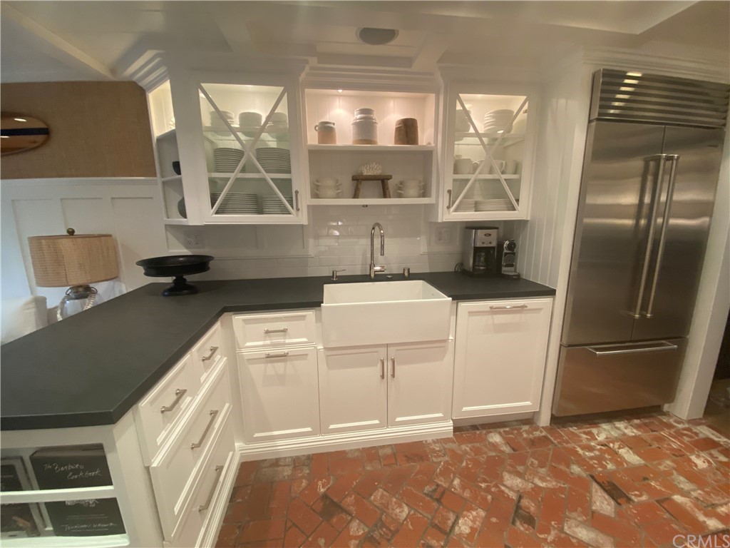 33965 Cape Cove Dana Point, CA 92629 - Photo 11 of 43 a kitchen with a refrigerator sink and cabinets