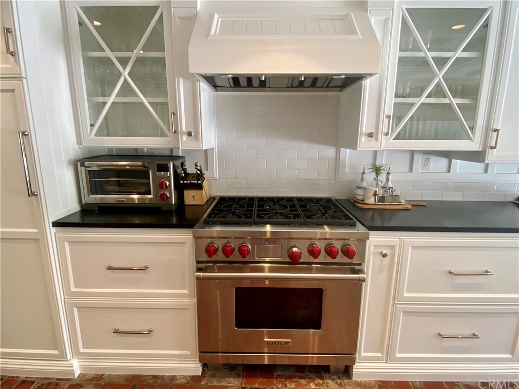 33965 Cape Cove Dana Point, CA 92629 - Photo 13 of 43 a kitchen with granite countertop a stove and a microwave