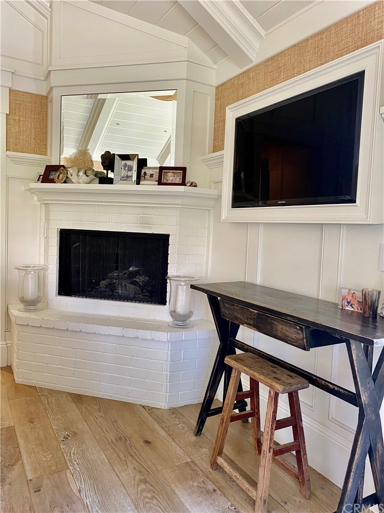 33965 Cape Cove Dana Point, CA 92629 - Photo 27 of 43 a living room with a flat screen tv a rug and white walls