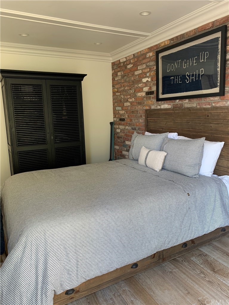 33965 Cape Cove Dana Point, CA 92629 - Photo 32 of 43 a bedroom with a bed and a wall painting