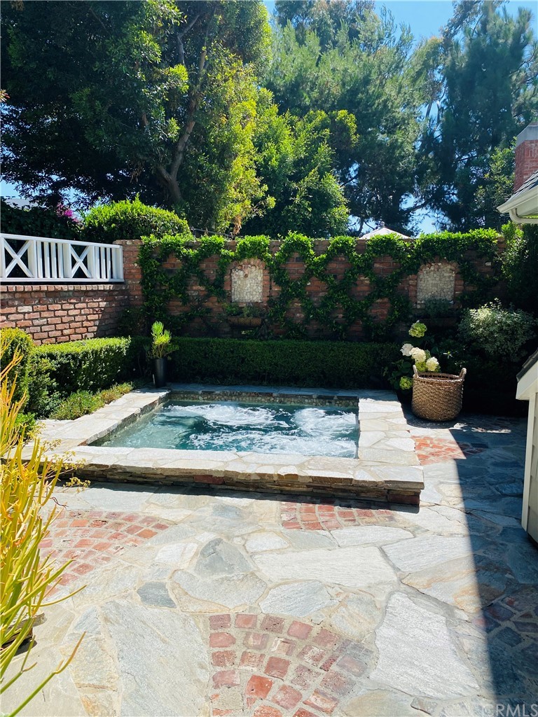 33965 Cape Cove Dana Point, CA 92629 - Photo 4 of 43 a view of a garden with plants and a bench