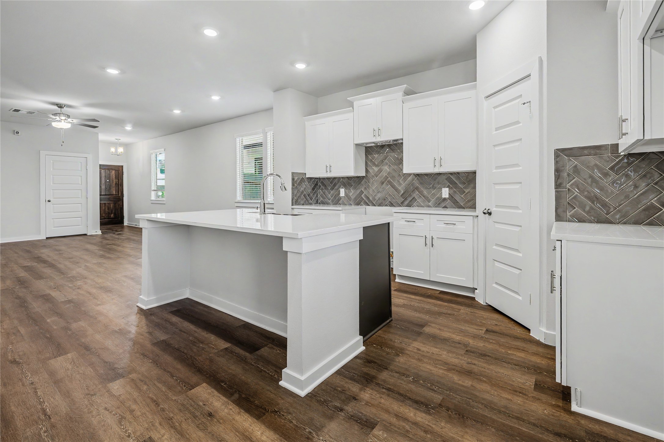 6423 Bolinas Court Rosharon, TX 77583 - Photo 9 of 39 a kitchen with stainless steel appliances granite countertop a stove a sink and white cabinets