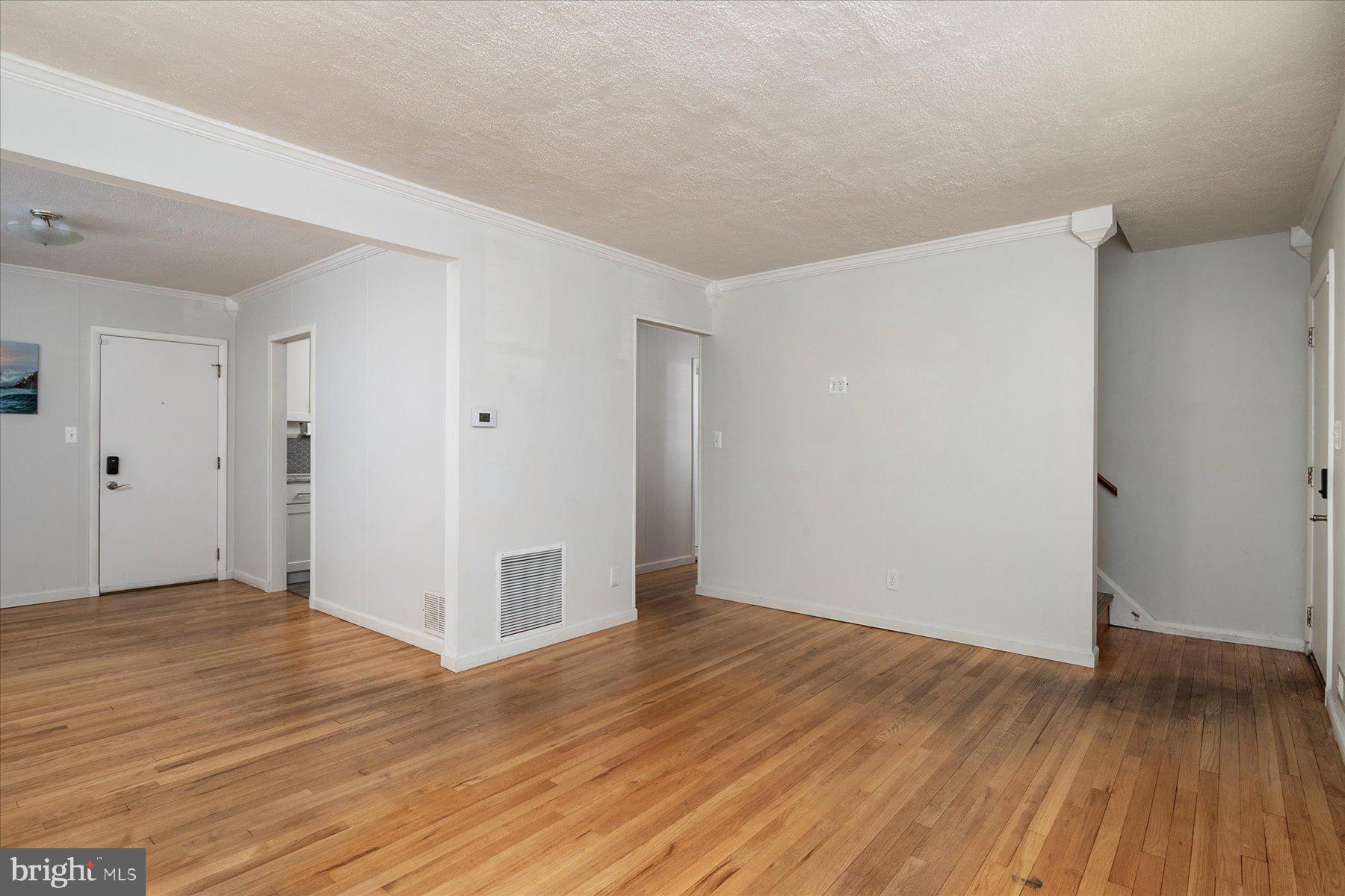 45 Clipper Road Essex, MD 21221 - Photo 8 of 36 a view of an empty room with wooden floor