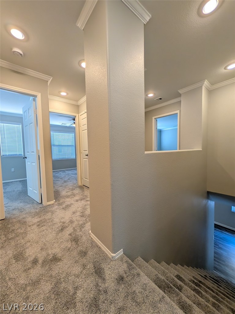 10308 Faustine Avenue Las Vegas, NV 89129 - Photo 14 of 28 Recessed lighting illuminates the upper-level landing, guiding the path to well-appointed rooms and a lower-level descent.