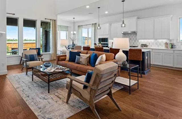 a living room with furniture appliances and wooden floor