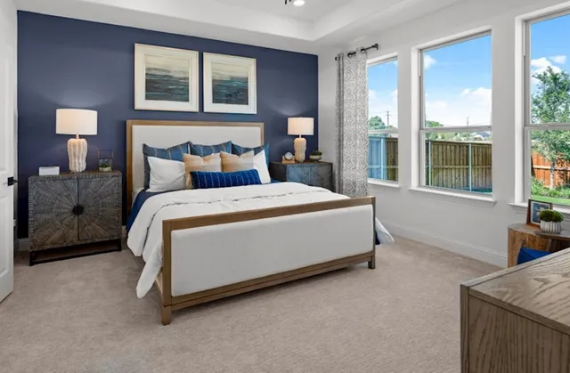 a bed sitting in a bedroom next to a window