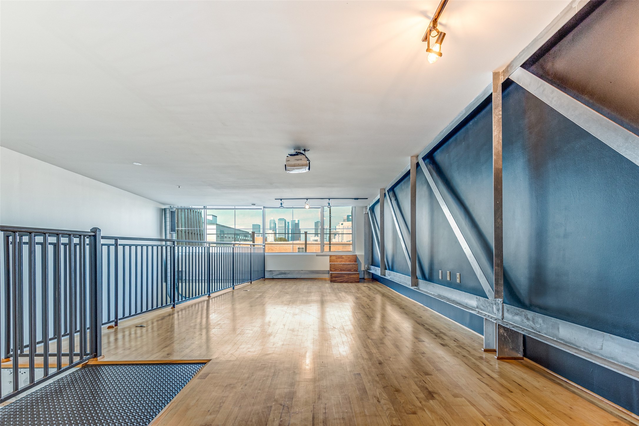 1312 Live Oak Street, Unit 223 Houston, TX 77003 - Photo 24 of 31 Versatile second floor loft area featuring a ceiling mounted projector with downtown city views.