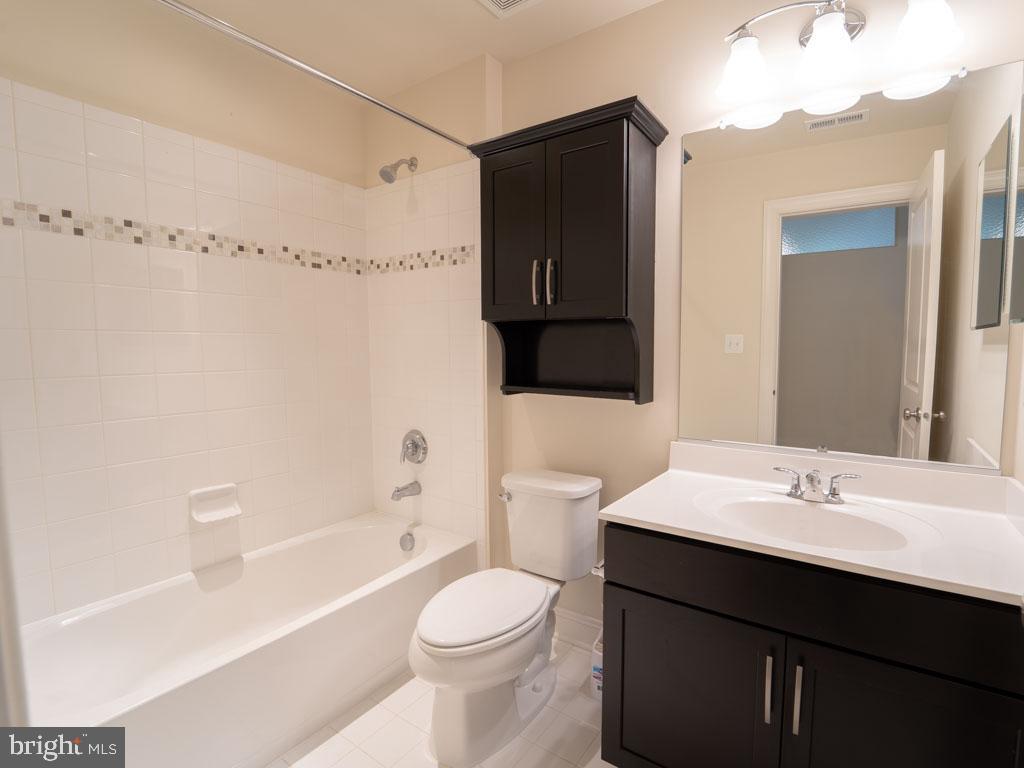 22595 Windsor Locks Square Ashburn, VA 20148 - Photo 53 of 56 a bathroom with a sink a toilet and shower