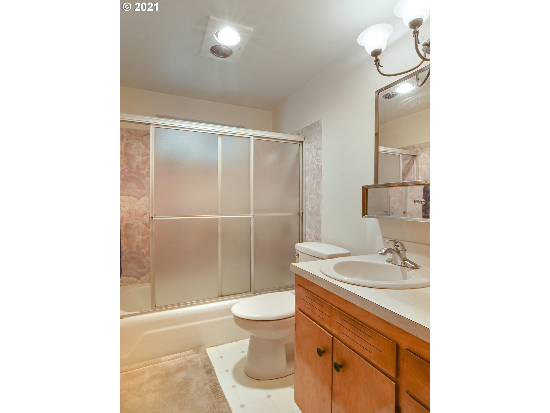 1509 6th Street Springfield, OR 97477 - Photo 16 of 30 a bathroom with a granite countertop sink a toilet a mirror and shower