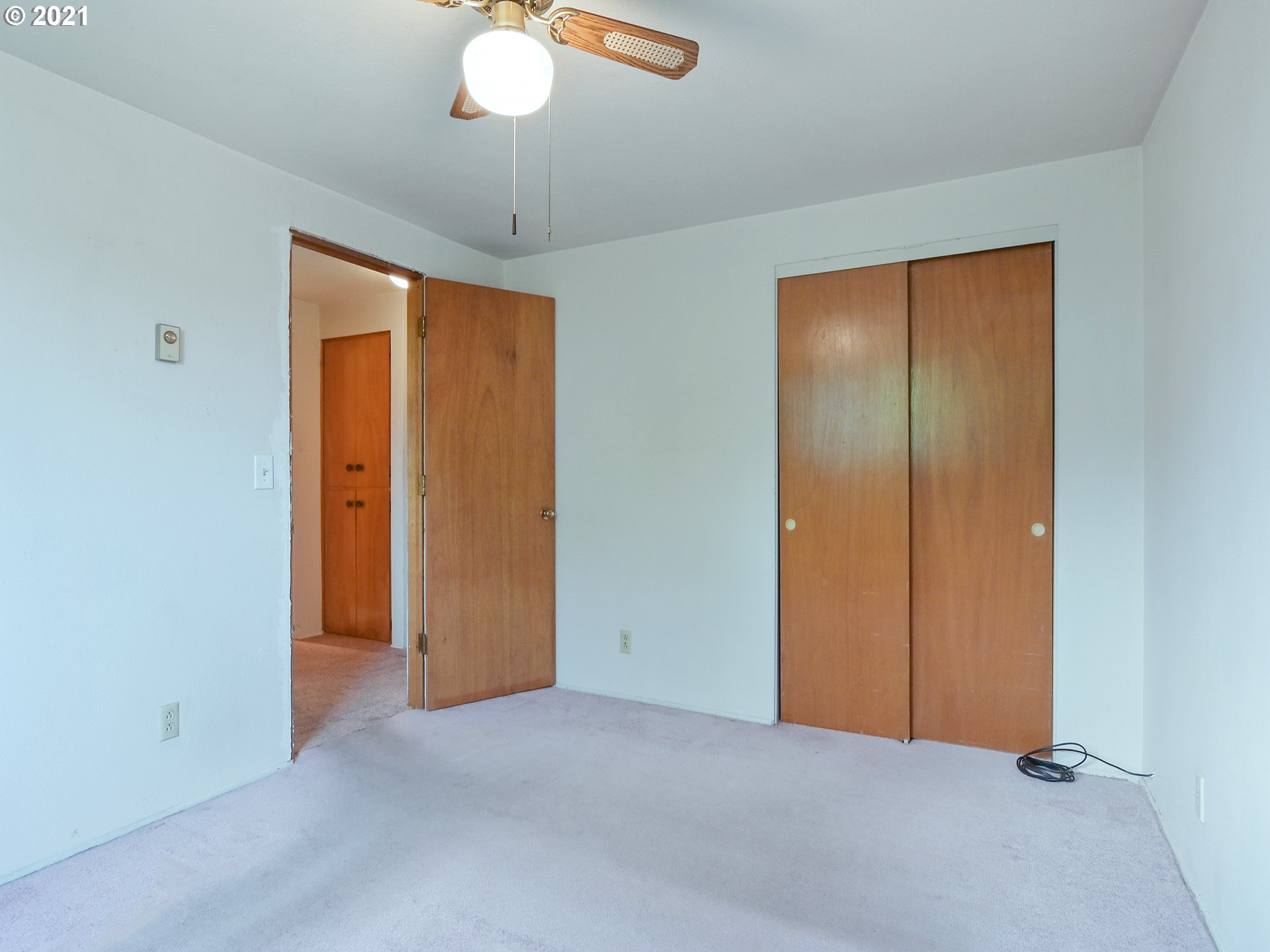 1509 6th Street Springfield, OR 97477 - Photo 19 of 30 an empty room with closet and a chandelier fan