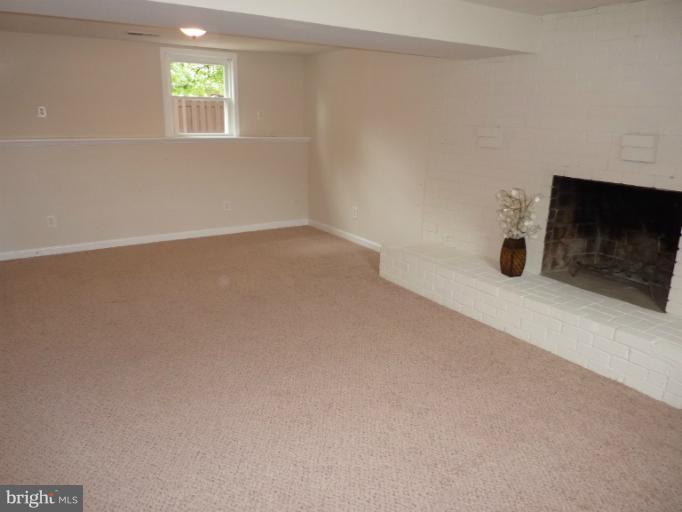 123 Little Whim Road Fredericksburg, VA 22405 - Photo 16 of 17 an empty room with windows and fireplace