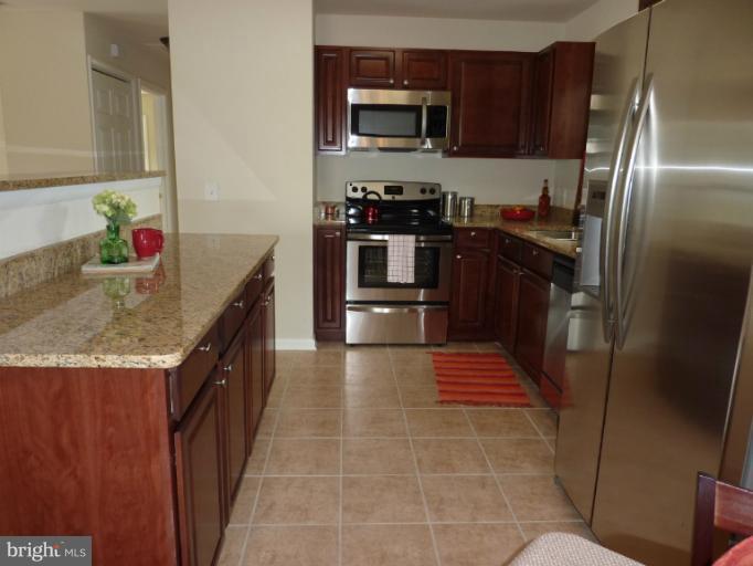 123 Little Whim Road Fredericksburg, VA 22405 - Photo 2 of 17 a kitchen with stainless steel appliances granite countertop a refrigerator a stove and a sink