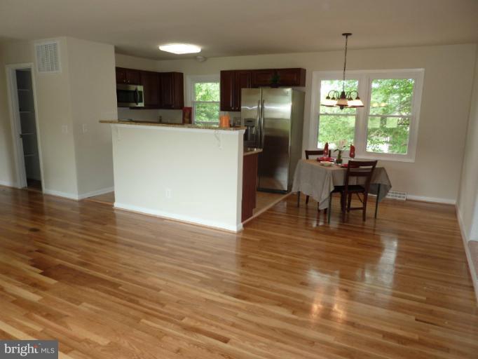 123 Little Whim Road Fredericksburg, VA 22405 - Photo 4 of 17 a view of a dining room with furniture window and wooden floor