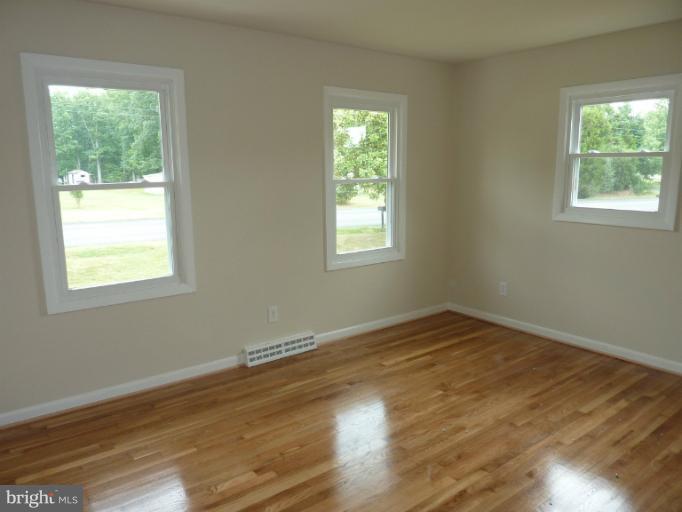 123 Little Whim Road Fredericksburg, VA 22405 - Photo 5 of 17 a view of an empty room with wooden floor and a window