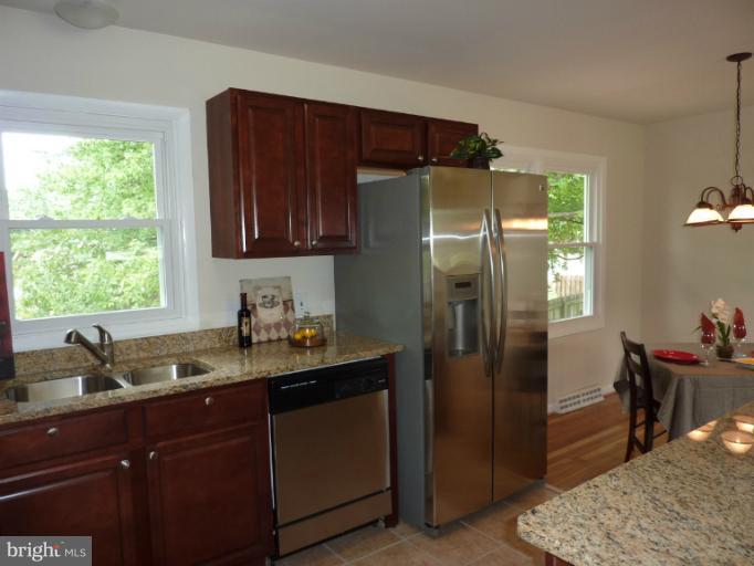 123 Little Whim Road Fredericksburg, VA 22405 - Photo 9 of 17 a kitchen with stainless steel appliances granite countertop a refrigerator and a sink
