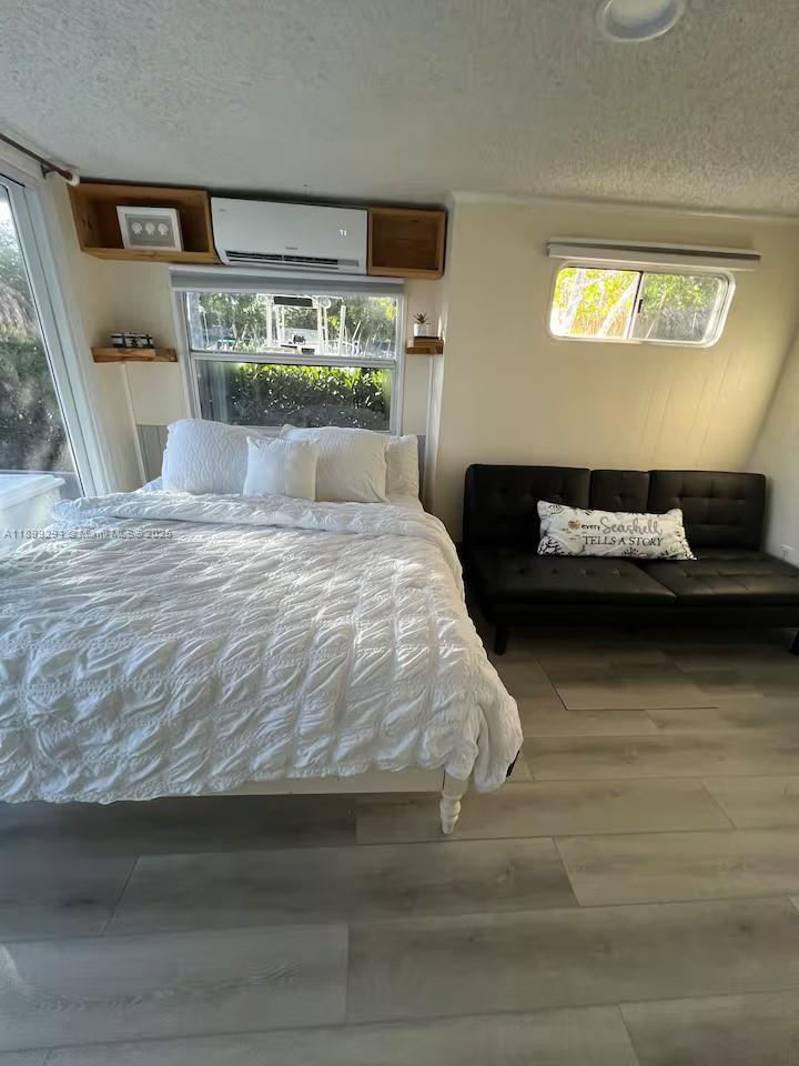 100 Morris Lane, Unit B2 Key Largo, FL 33037 - Photo 21 of 49 a bedroom with a bed and a large window
