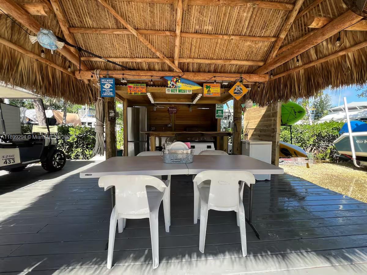 100 Morris Lane, Unit B2 Key Largo, FL 33037 - Photo 29 of 49 a view of a patio with table and chairs with wooden floor