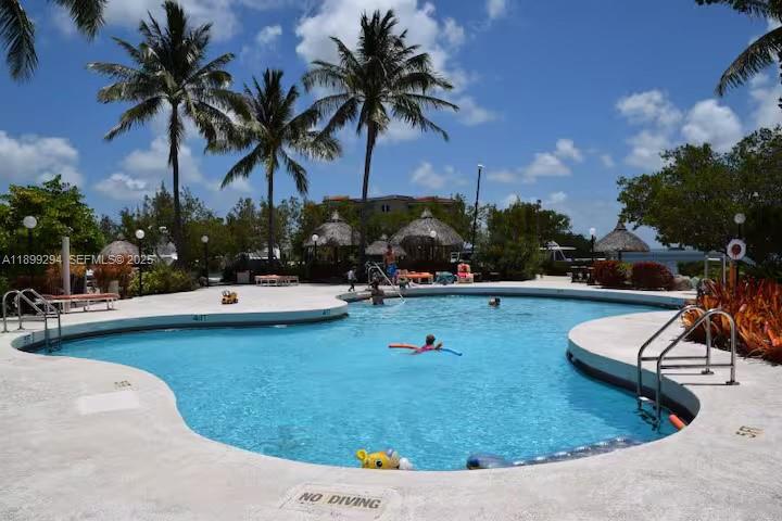 100 Morris Lane, Unit B2 Key Largo, FL 33037 - Photo 42 of 49 a view of a swimming pool and lounge chair