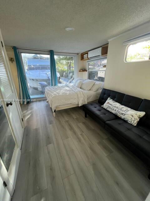 100 Morris Lane, Unit B2 Key Largo, FL 33037 - Photo 6 of 49 a bedroom with a bed and wooden floor