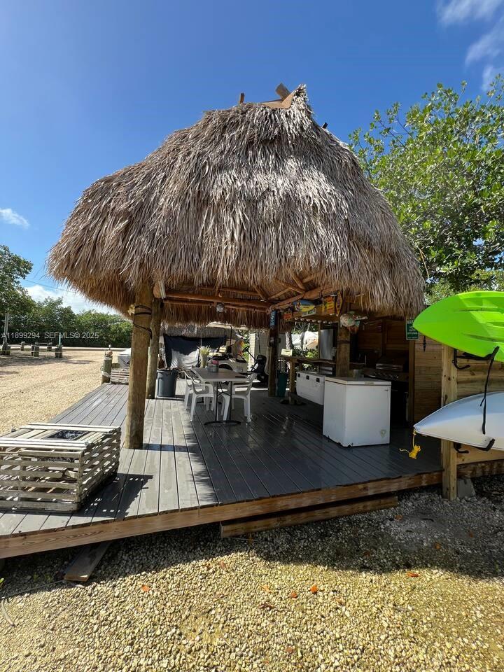 100 Morris Lane, Unit B2 Key Largo, FL 33037 - Photo 8 of 49 a view of a patio with lawn chairs under an umbrella
